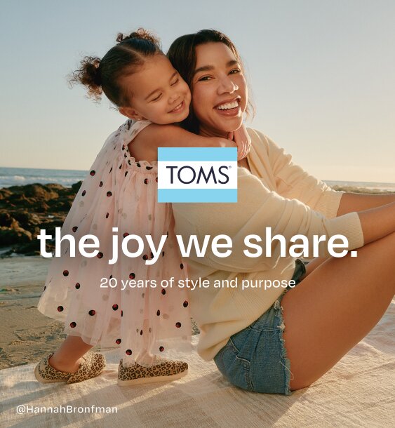 TOMS logo. the joy we share. 20 years of style and purpose. Caption: @HannahBronfman. Daughter hugging Hannah. Beach background.