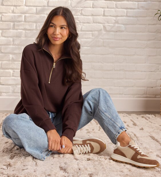 Model wearing TRVL LITE Retro Runner Sneaker.