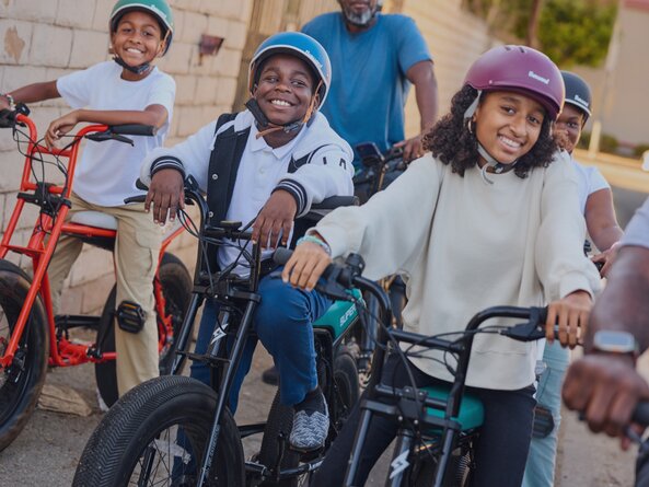 A group of kids riding bikes.