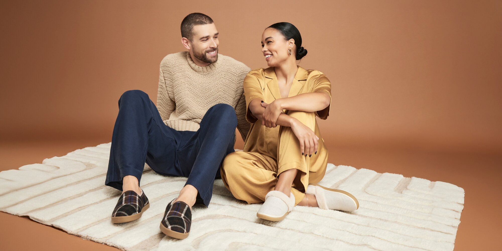 Women's Oslo and Men's Camden slippers in various colors shown.