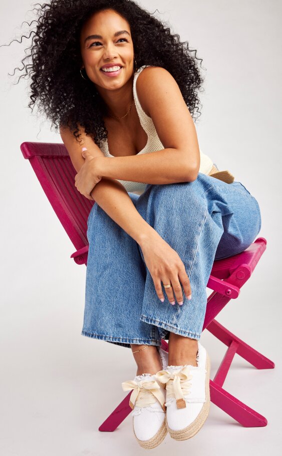 Model wearing Women's Carolina Lace-Up Espadrille in white beachside woven shown. 