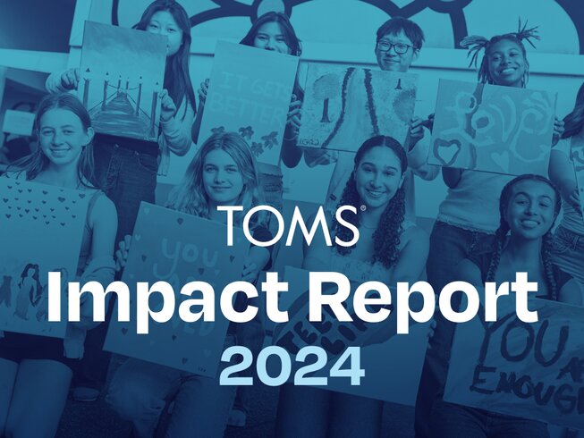 A group of kids holding paintings. TOMS Impact Report 2024.