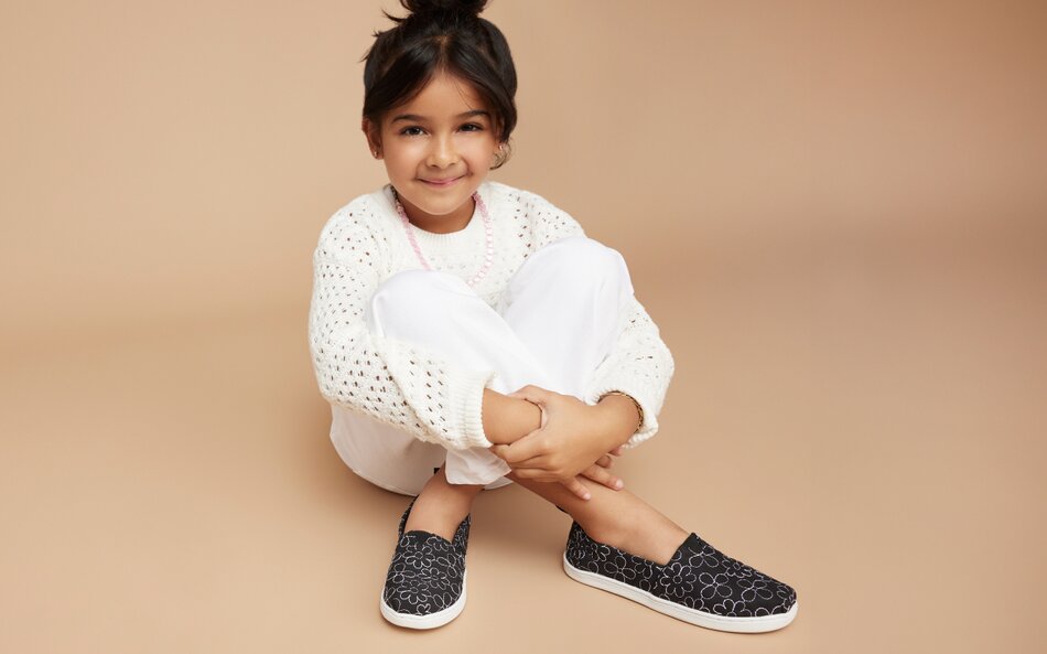 Alpargata Kids Shoes in black quilted daisy shown.