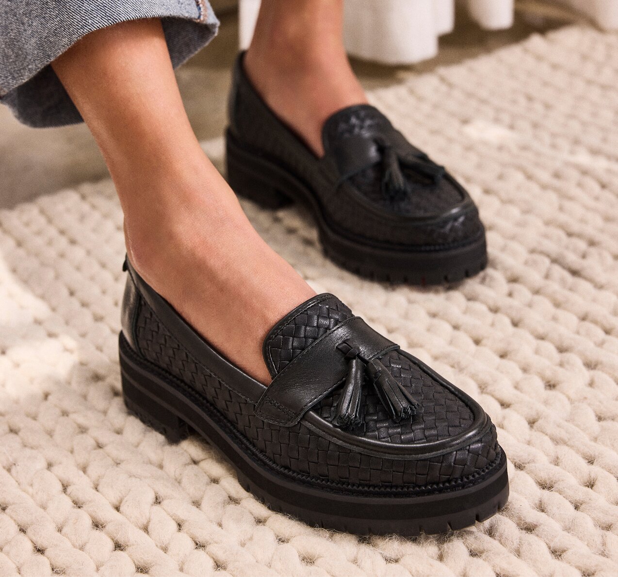 Women's Cara Tassel Loafer in black leather backetweave shown.