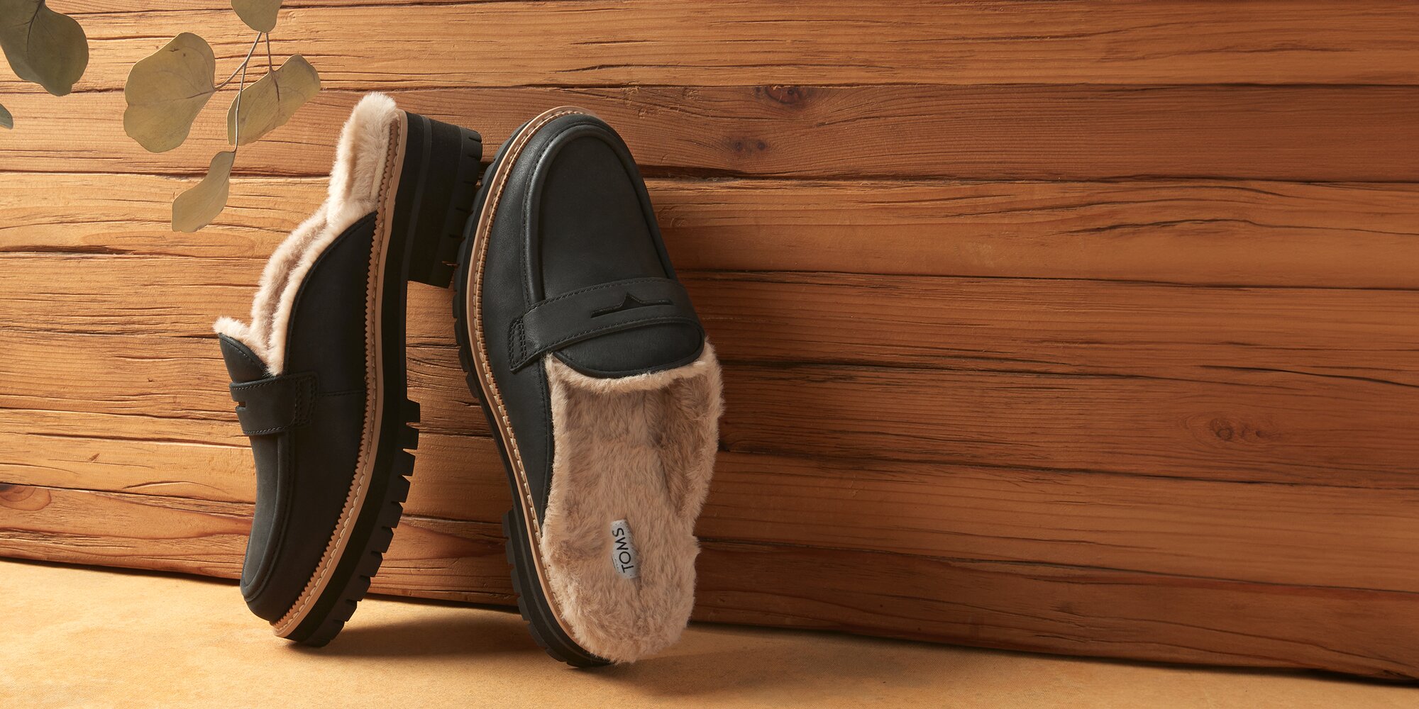 Women's Cara Mule Cozy Loafer in black faux fur leather shown.