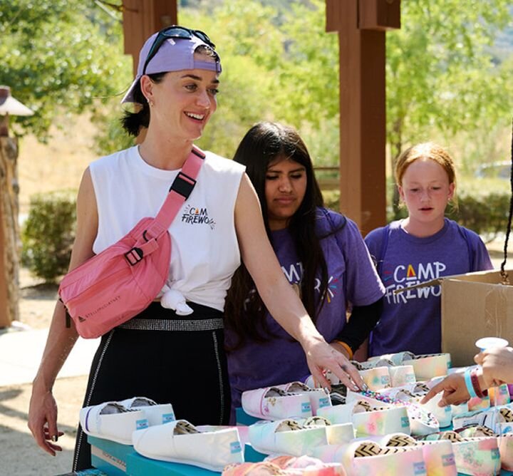 Child holding TOMS shoe box.