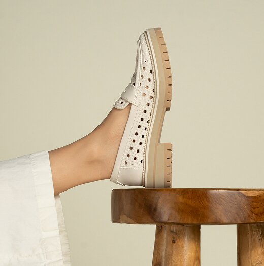 Model wearing Cara Loafer in Light Sand Leather Embossed Perforated.