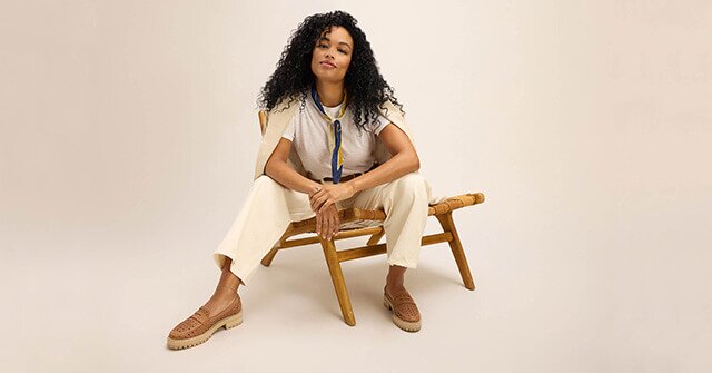 Model wearing the embossed perforated Cara Loafer in brown sugar  shown.