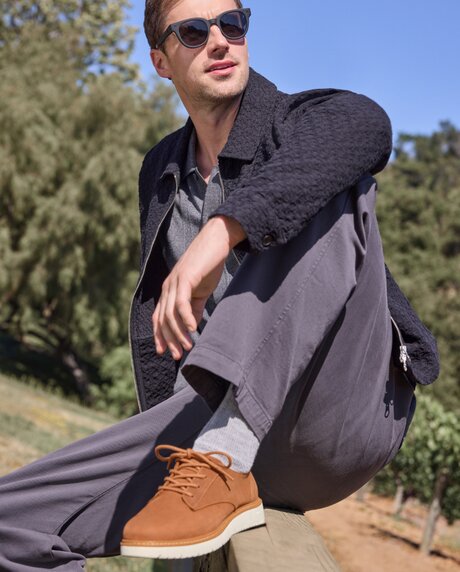 Model wearing Navi TRVL LITE Water Resistant Tan.