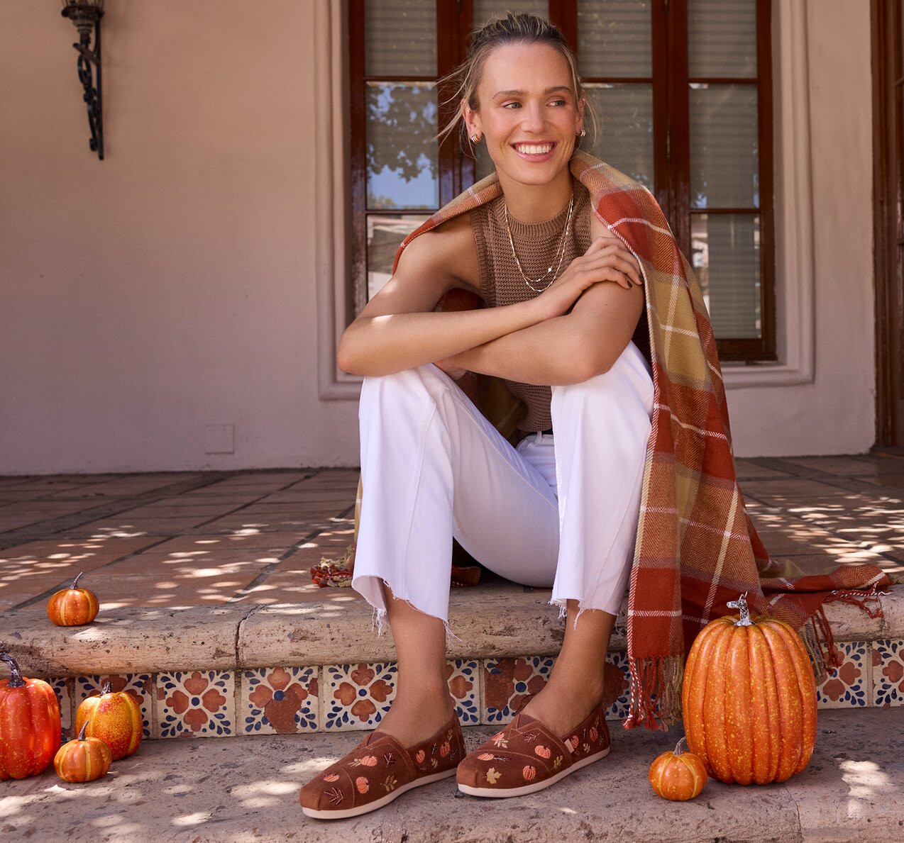 Model wearing Alpargata Classic in amber brown corduroy embroidered pumpkins shown.