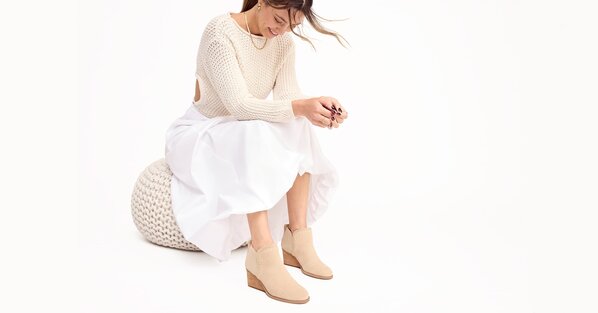 Model wearing the natural suede Kaia Wedge Ankle Boot shown.