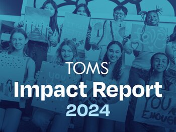 A group of kids holding paintings. TOMS Impact Report 2024.
