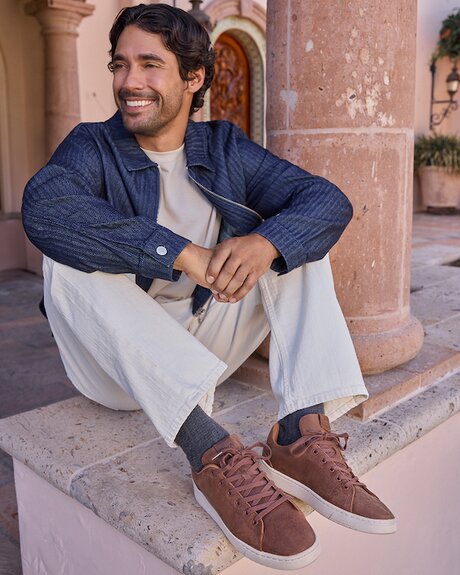 Model wearing men's TRVL LITE Lace-Up Sneaker in tan leather shown.