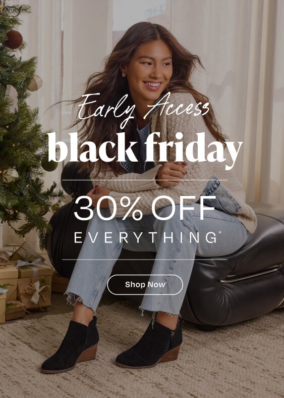 Early Access black friday. 30% OFF Everything*. Model wearing Women's Goldie Wedge Ankle Bootie in black suede shown.