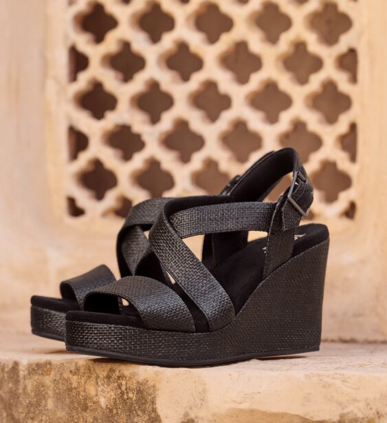 Women's Alondra Wedge Sandal in black raffia shown.