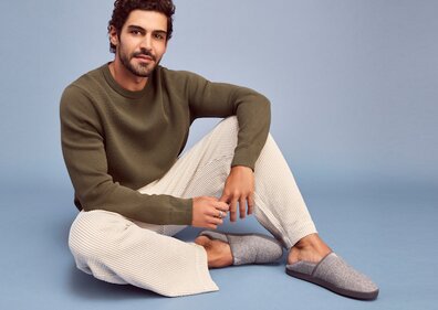 Model wearing Camden Slipper in grey shown.