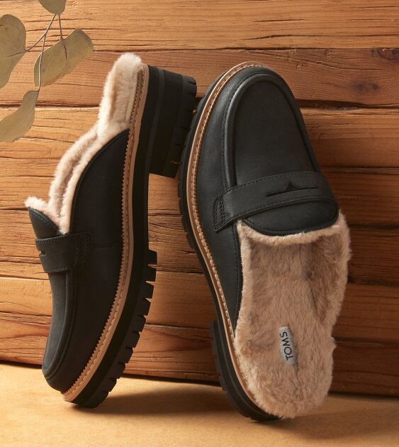 Women's Cara Mule Cozy Loafer in black faux fur leather shown.