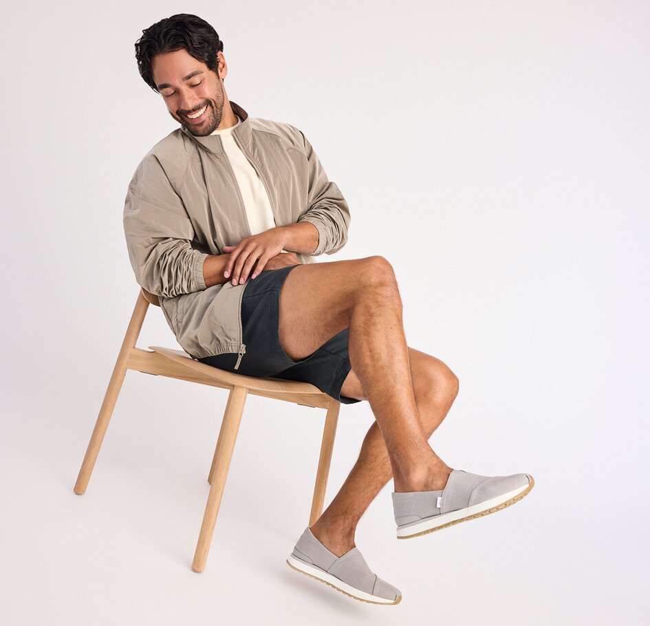 Model wearing men's TOMS footwear shown.