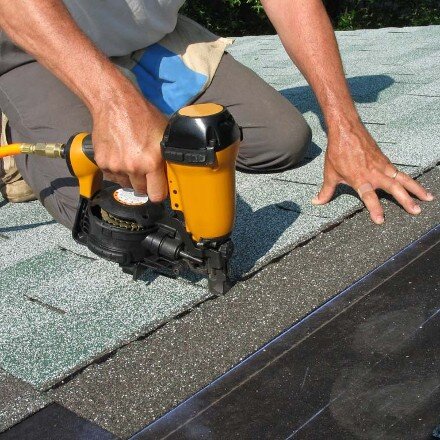 Worker using nail gun