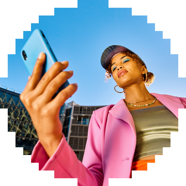 Man using a phone indoors beside a Mimo Certificate of Completion for HTML.