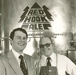 Gordon Bowker and Paul Shipman standing in front of a Redhook distilling tank.
