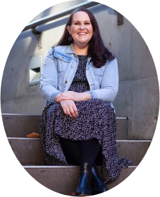 Photo of Morwenna sitting on some steps smiling