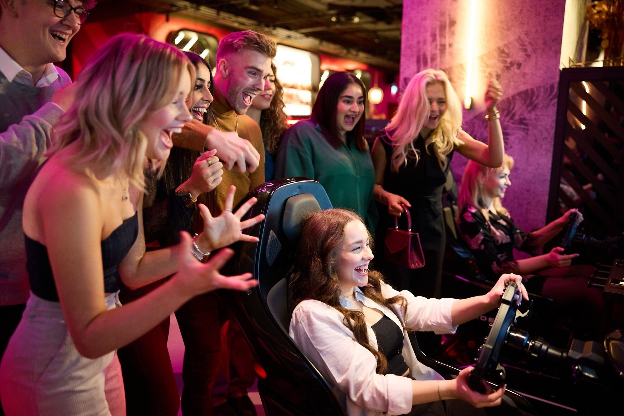 Group enjoying racing at F1 Arcade