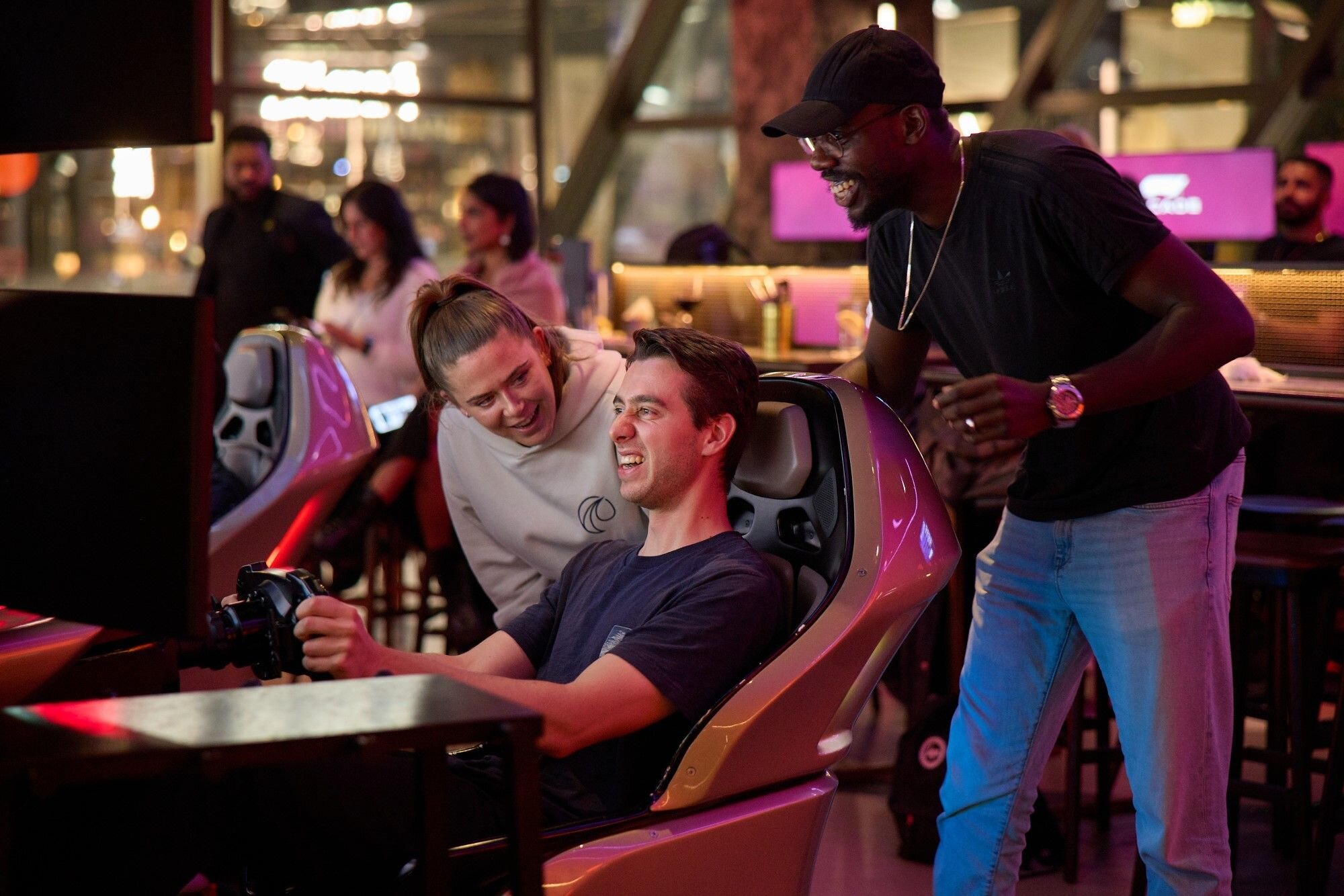 Group enjoying racing at F1 Arcade