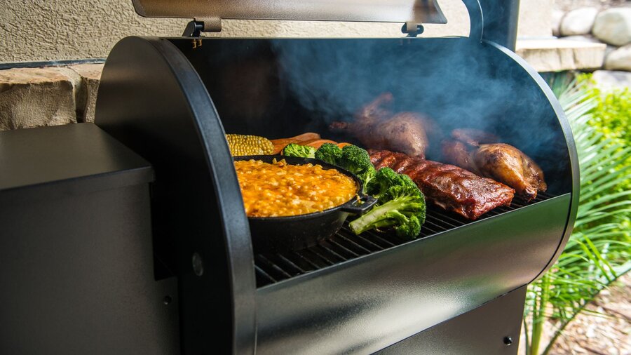 A Traeger BBQ filled with winter foods.