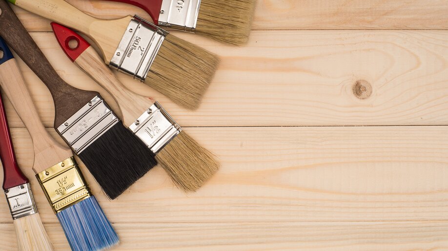 Paint Brushes on Wooden Background