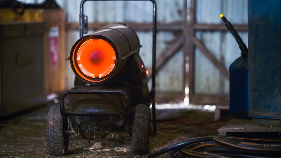 A kerosene heater giving off heat in a workshop.