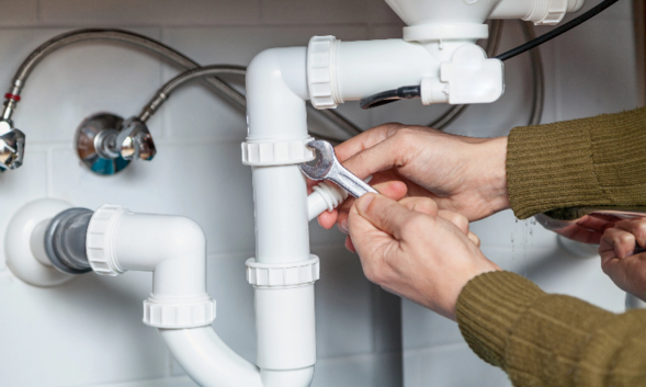 Plumber fixing the pipe