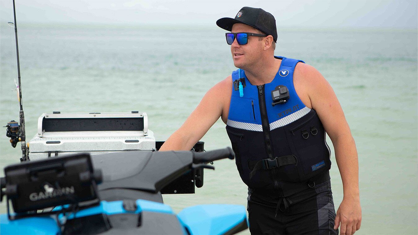 A man wearing a jet ski life jacket