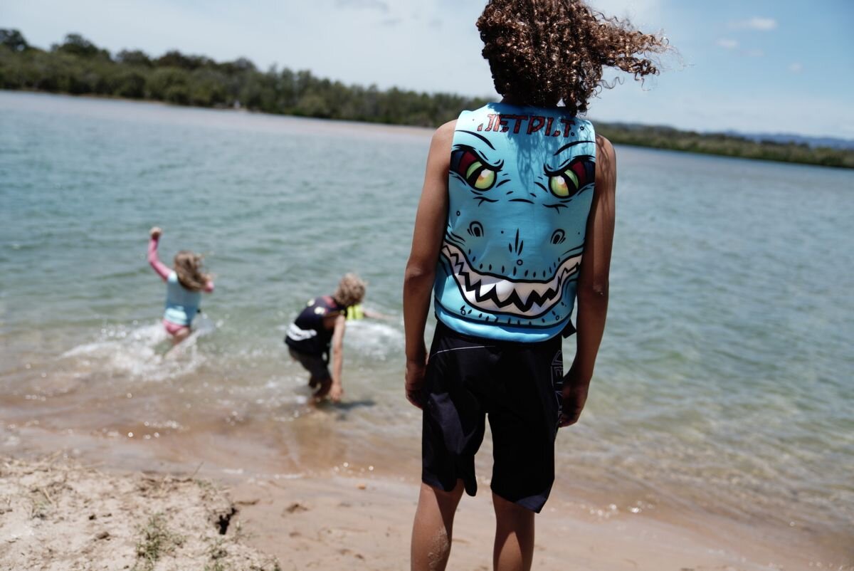 A boy wearing a neoprene life jacket