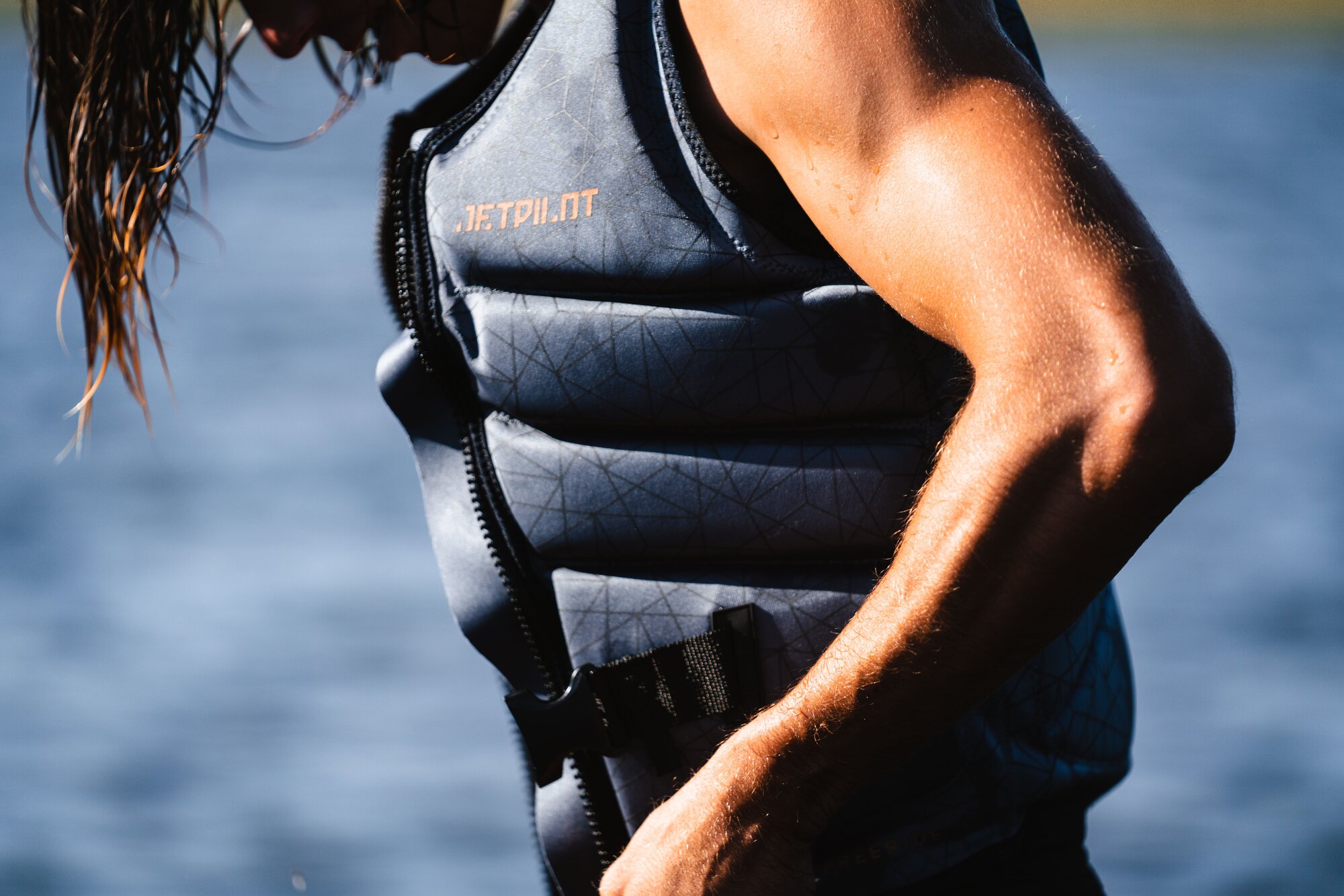 A man fitting a wakeboarding life jacket