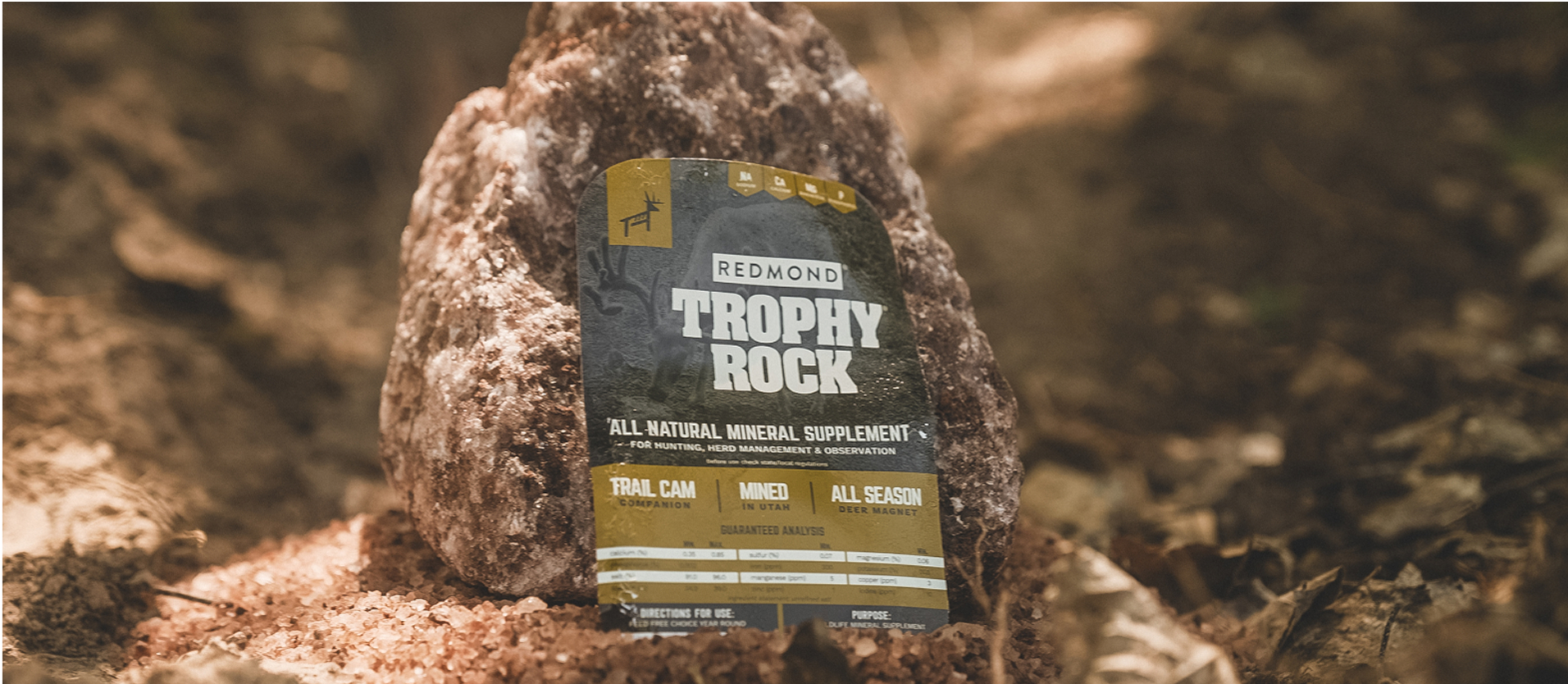A wrapped Trophy Rock--the #1 selling deer mineral--being placed on the ground.