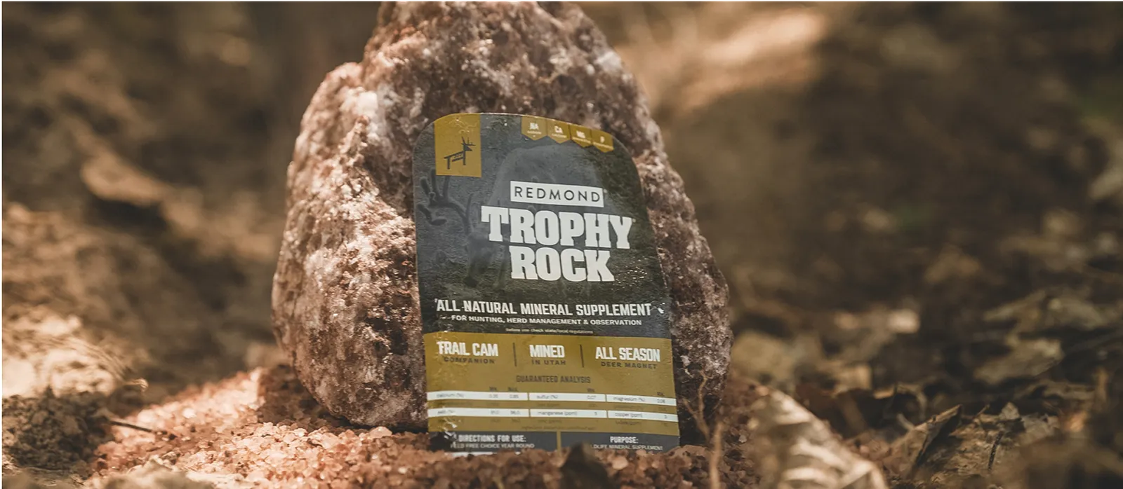 A wrapped Trophy Rock--the #1 selling deer mineral--being placed on the ground.