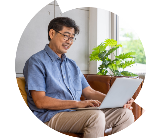 Man in glasses working on a laptop