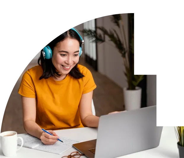 A smiling woman with laptop and headphones