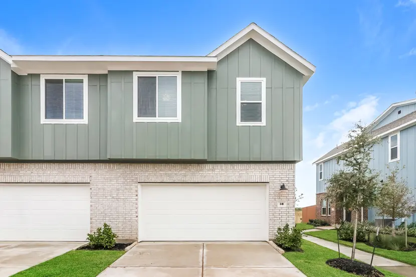 Exterior of a two-story modern suburban home with brick and siding exterior