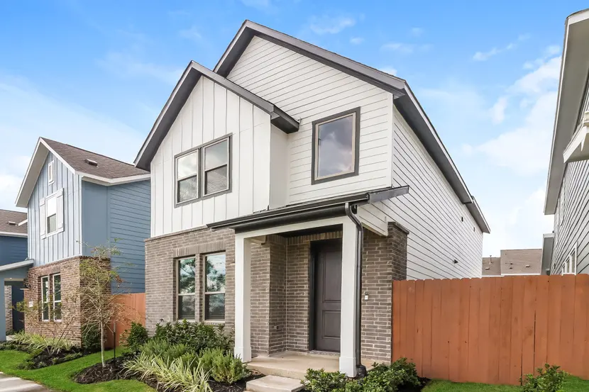 Exterior of a two-story modern suburban home with brick and siding exterior