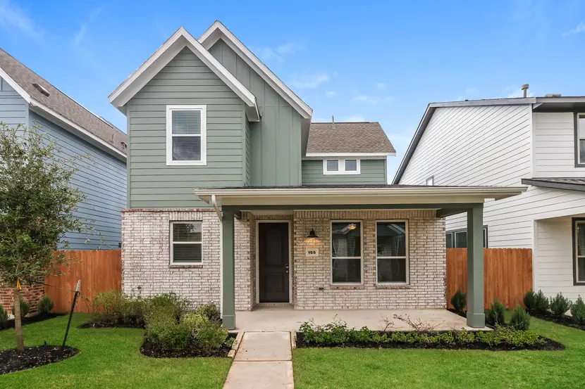 Exterior of a two-story modern suburban home with brick and siding exterior