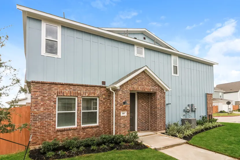 Exterior of a two-story modern suburban home with brick and siding exterior