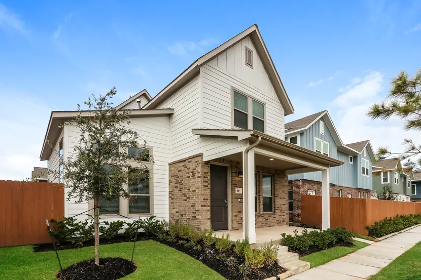 Exterior of a two-story modern suburban home with brick and siding exterior