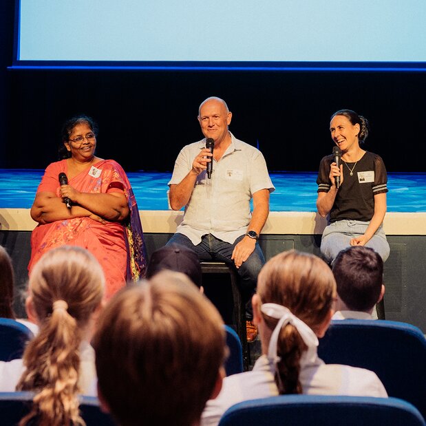 Panel discussion with speakers and students in an auditorium
