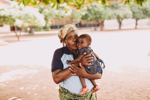 a mother holding her baby