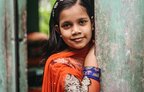 a happy young girl looking into the camera