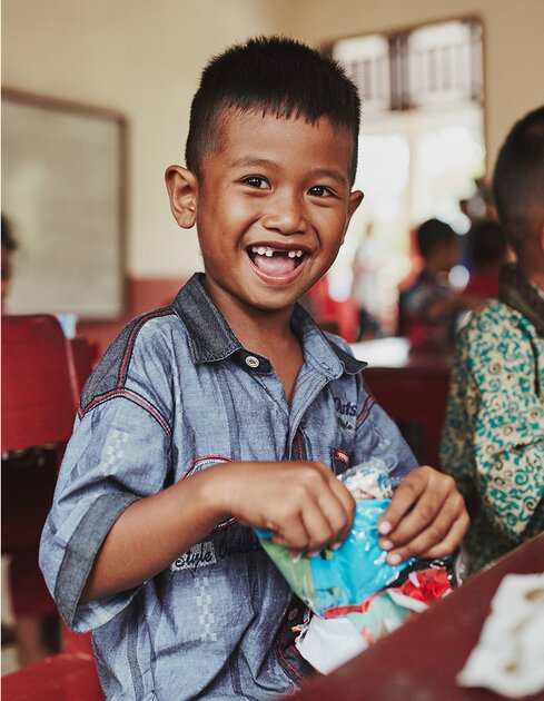 smiling boy opening a gift