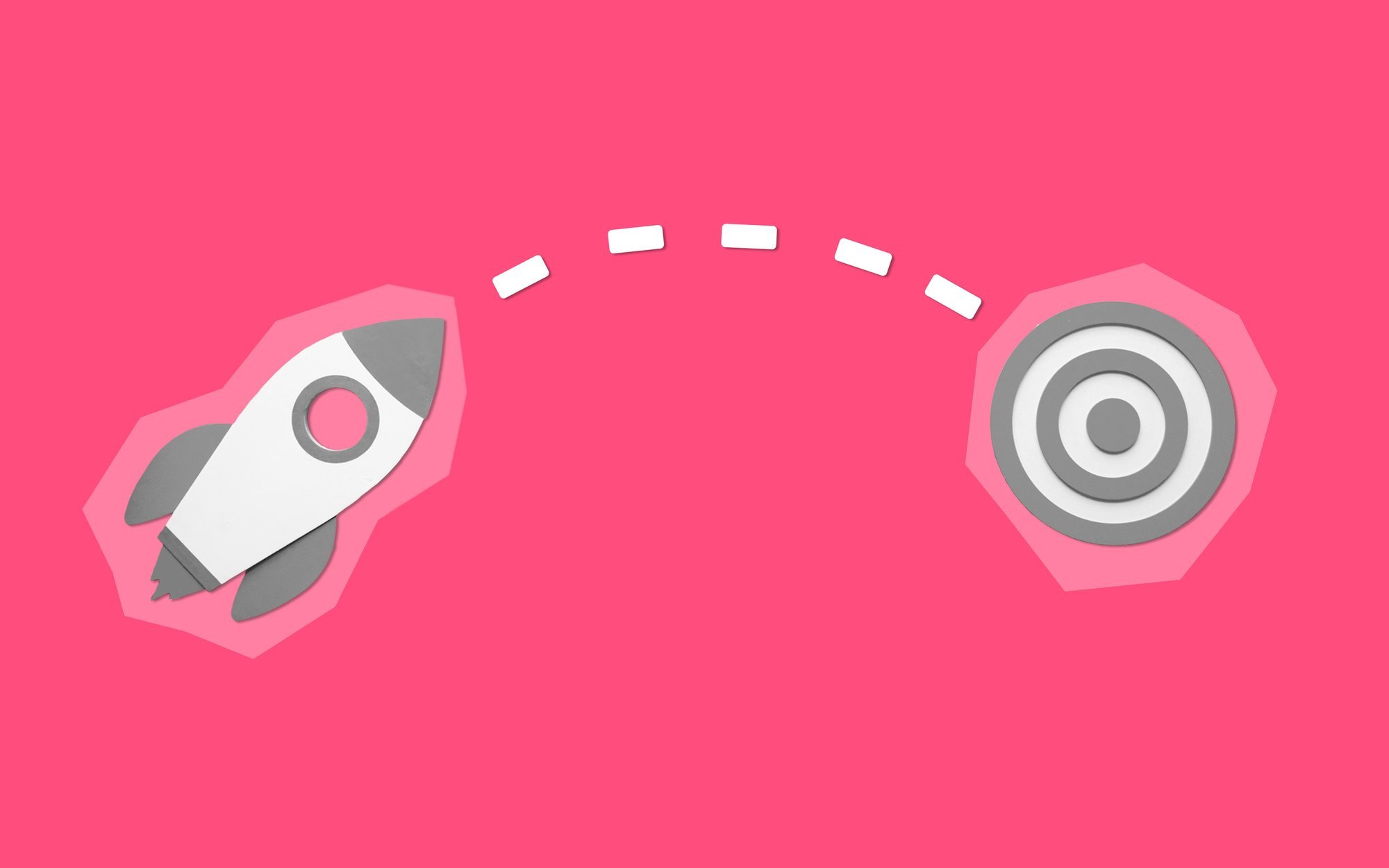 Cut-out images of a rocket on a path to a bullseye target on a bright pink background.