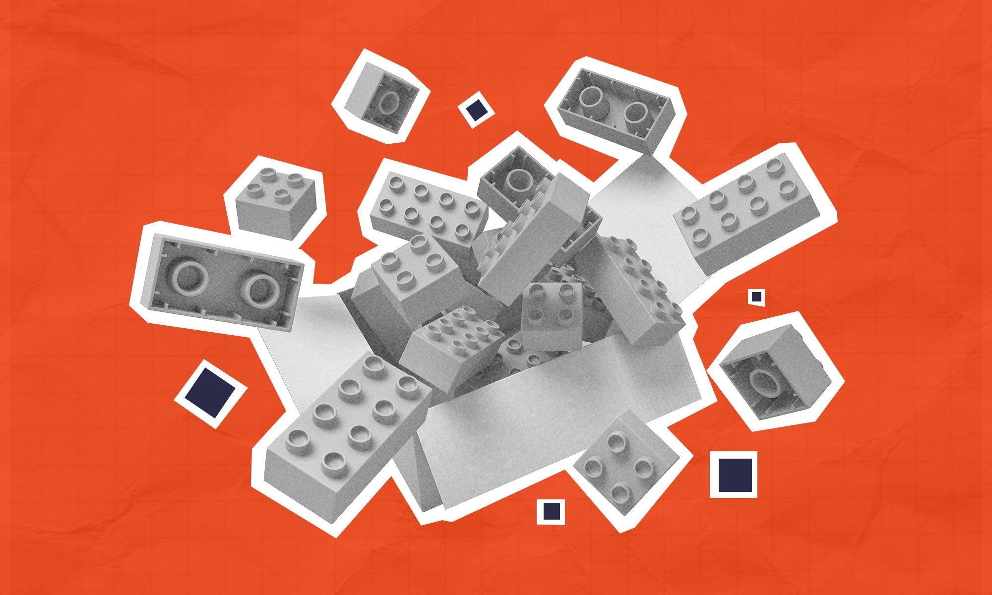 An assortment of legos bursting from a cardboard box.